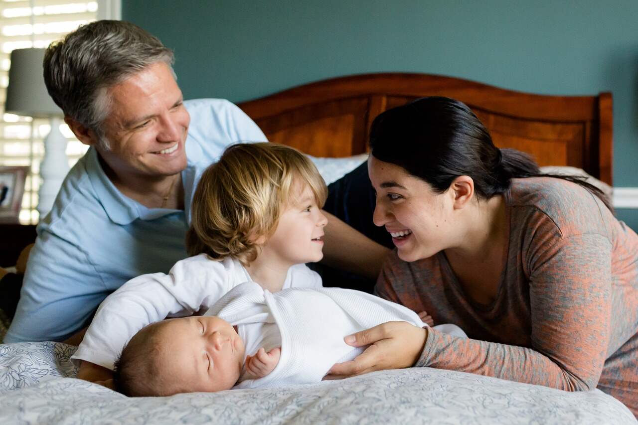 four-member family on bed