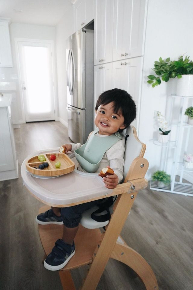 Toddler wearing a blue silicone bib