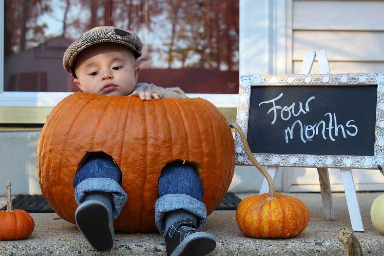 baby dressed in a pumpkin