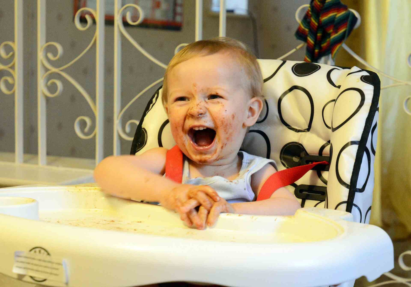 baby laughing in a high chair