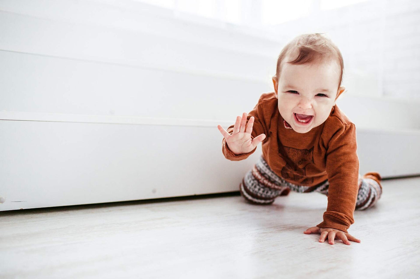 baby girl crawling and smiling