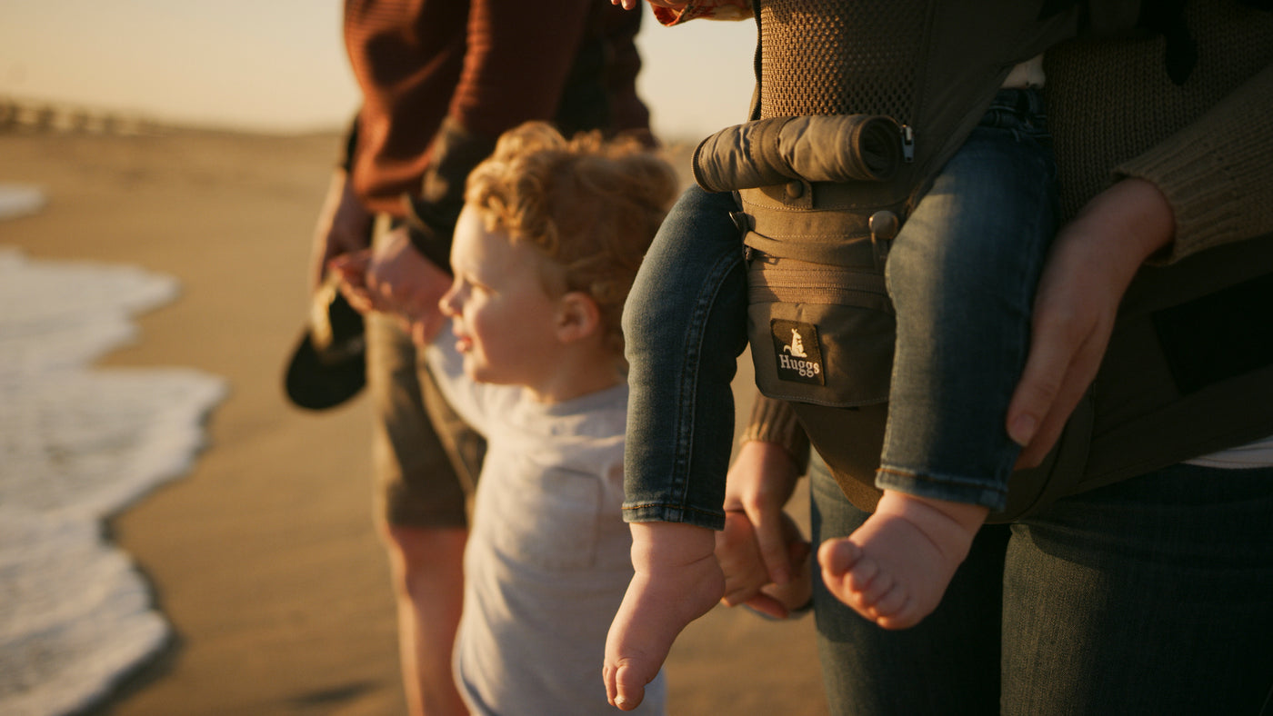 family of four featuring Huggs Baby Carrier