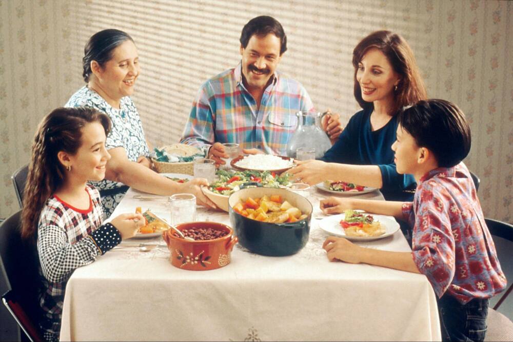 group of persons eating outdoors