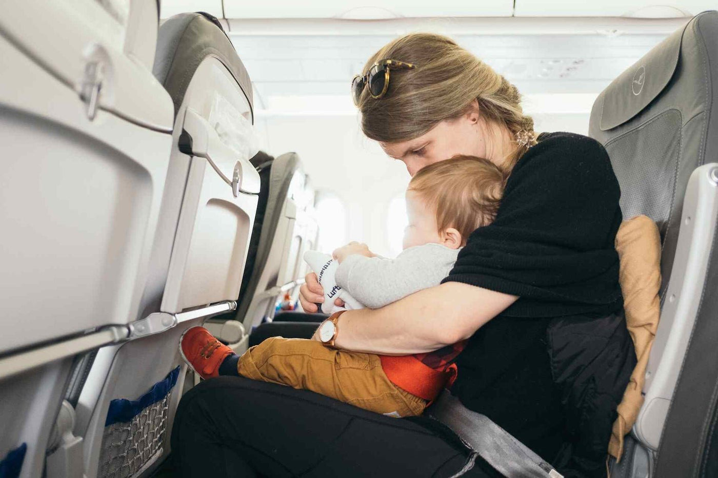 parent traveling with a baby in a plane