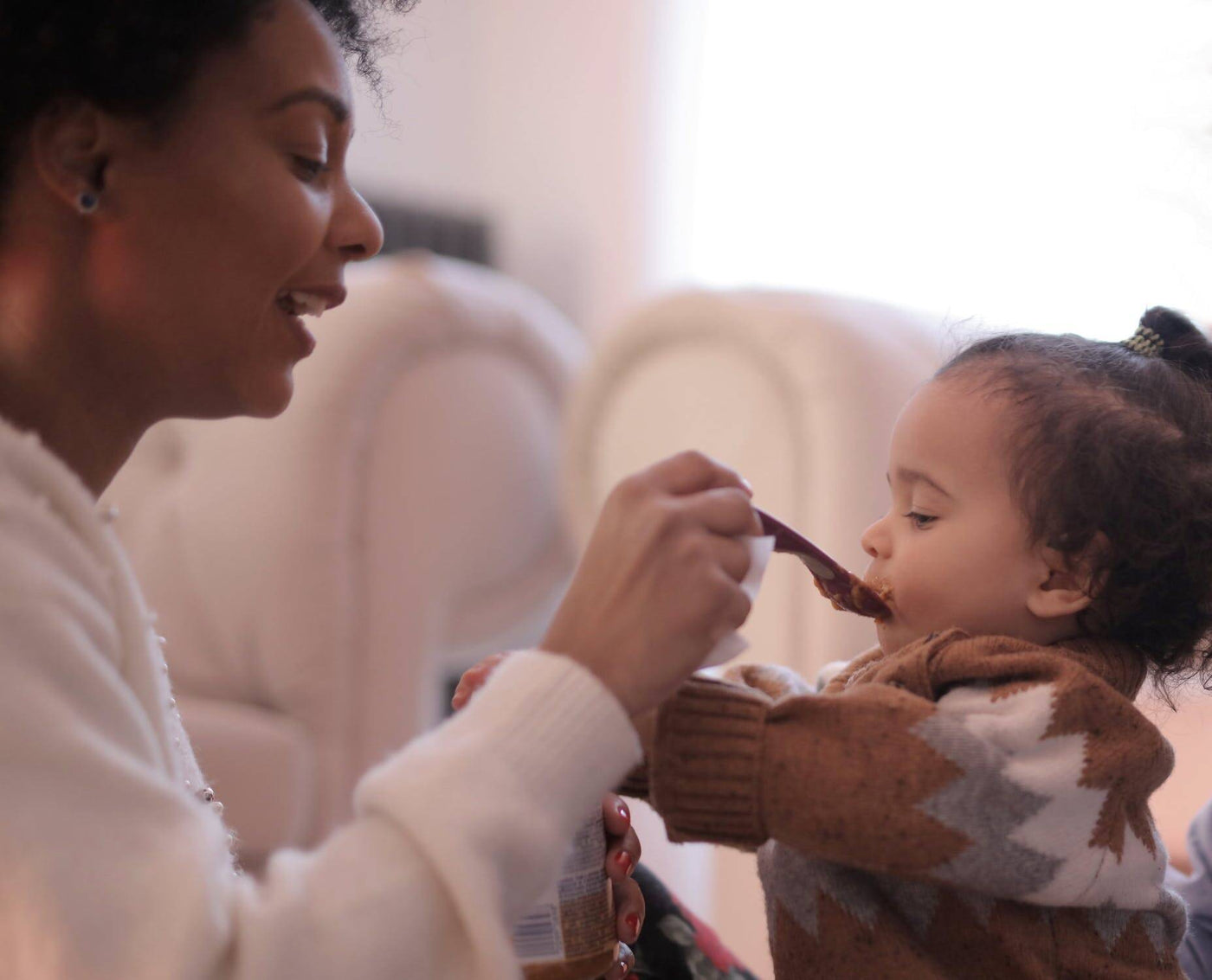 woman feeding baby who’s a picky eater